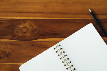Blank notepad with pencil on office wooden table
