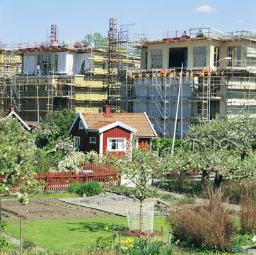 Construction site with house in foreground