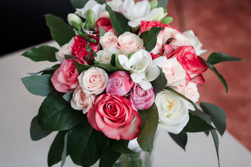 a bridal bouquet of roses, freesia, carnations and fat. top view