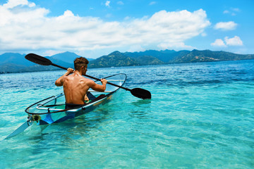 Summer Travel Kayaking. Man Canoeing Transparent Kayak In Ocean