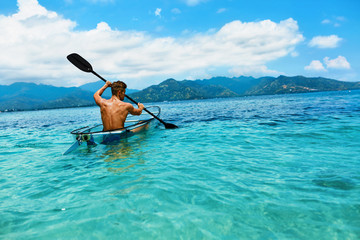 Summer Travel Kayaking. Man Canoeing Transparent Kayak In Ocean
