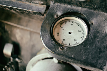 Old abandoned industrial engine that was used in mining industry in the past. Detail of non-working pressure dial without needle