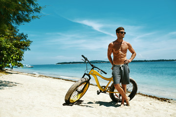 Fitness Male Model With Bike Sunbathing On Sun, Enjoying Summer Travel Vacation. Handsome Sexy Man...
