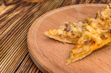 Pieces of pizza on a wooden board