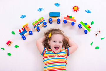 Little girl with wooden train