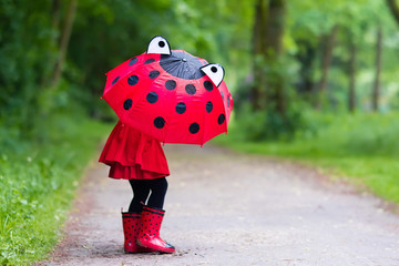 Little girl walking in the rain