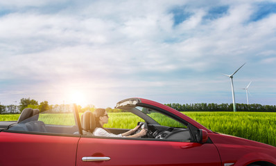 Girl in red cabriolet.
