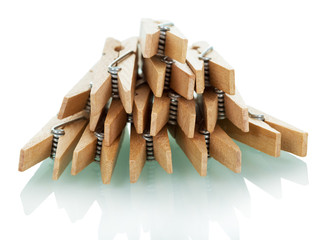 Pile of wooden clothespins isolated on white.