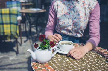 Young woman having coffee outside