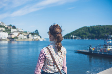 Young woman standing by water in small village