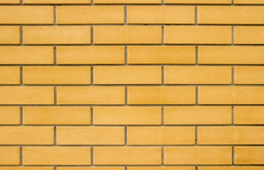 beige brick wall. / New flat brick wall of beige color with deep seams.