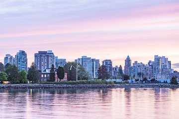 High-rise buildings, Westin Hotel near Coal Harbour Quay at waterfront of Vancouver at sunset