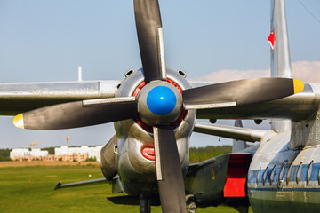 Old turboprop transport aircraft. Engine and propeller of the old retro transport plane close-up. Fragment of the aircraft.