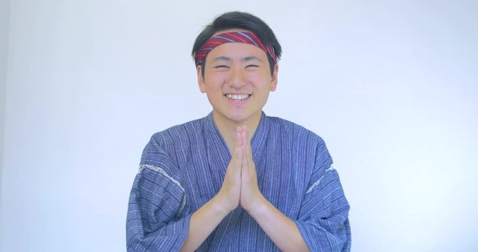 Japanese jimbe traditional clothes bows to the camera 