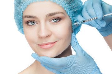 Attractive woman at plastic surgery with syringe in her face