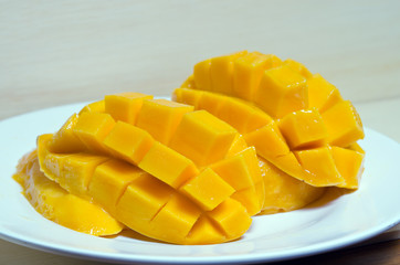 Ripe yellow mango on wooden background