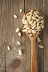 Pine nuts in wooden spoon