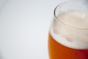 Glass of light beer isolated on a white background
