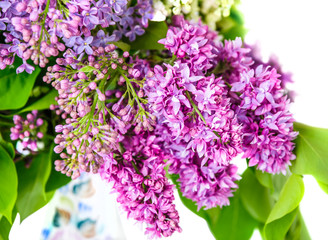 A fragment of a lilac bouquet  in a porcelain vase