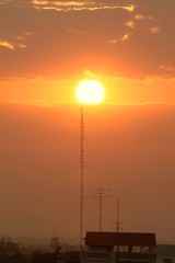 Telecommunication tower in golden sunset background