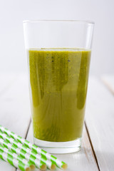 Healthy green detox with spinach, cucumber, lime and apples on white wooden table
