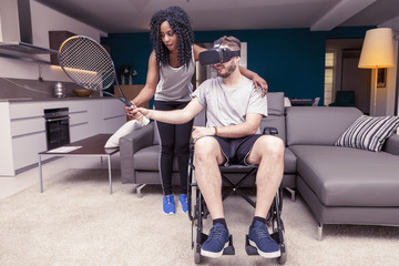young girl helps a disabled who plays tennis with augmented real
