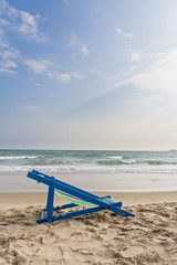 Fototapeta na wymiar Beach chair on the beach and sea background