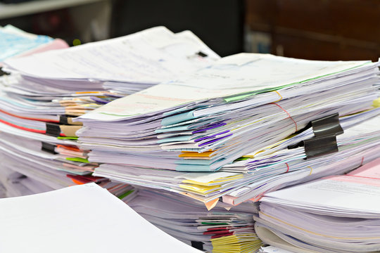 Close up of business documents stack or report papers stack on desk , selective focus