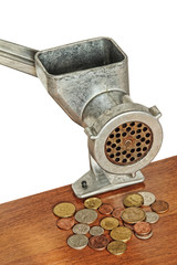 Meat grinder and coins on wooden table and white background.Toned image.