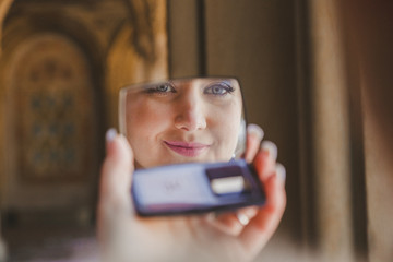 Gorgeous beautiful bride with green eyes mirror reflection face closeup
