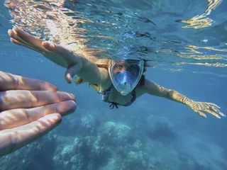 Fotobehang Beautiful woman under water before dive to coral reef © Elya.Q