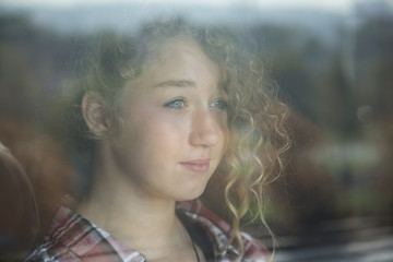 Portrait of Beautiful Redhead Girl Behind Glass with reflection