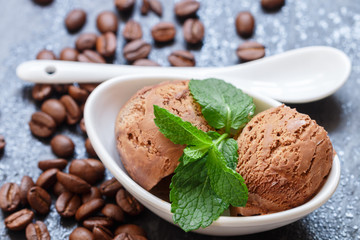 Coffee ice cream with mint leaves in a white Cup