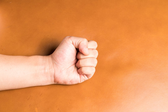 Hand on leather background