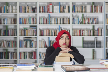 Portrait of handsome young student in the library