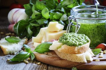 Bruschetta with fresh pesto sauce, hard cheese, nuts, basil, vin