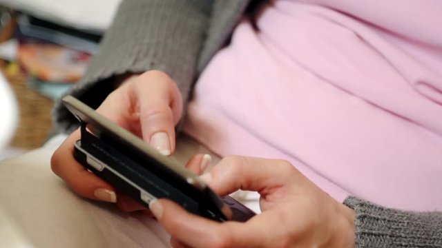 Female hands typing a message on a phone
