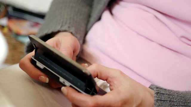 Female hands typing a message on a phone
