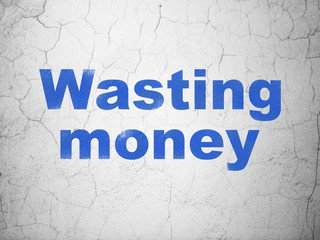 Banking concept: Wasting Money on wall background