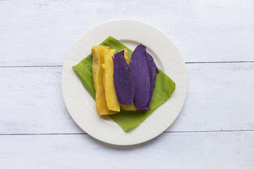 Healthy steamed sweet potato on white wooden background