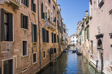 Fototapeta na wymiar Boats on small canal in Venice, Italy.