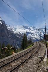 Obraz na płótnie Canvas Train line running through the Swiss Alps
