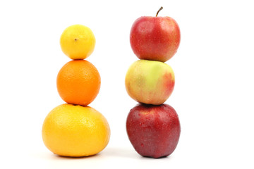 apples and citrus stand vertically on each other 