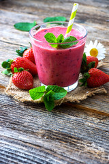 Summer  strawberry smoothie on rustic wooden background