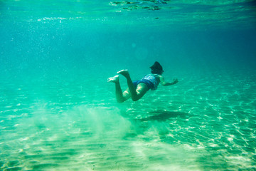 Underwater scene in Ionian sea, Zakynthos, Greece, with girls playing in the water