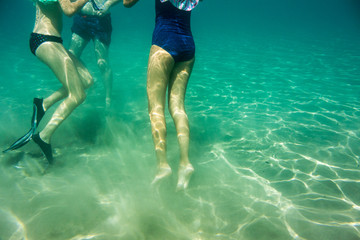 Underwater scene in Ionian sea, Zakynthos, Greece, with girls playing in the water