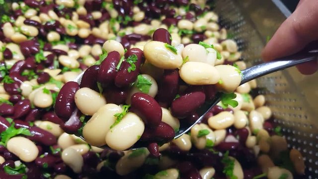 Blending butter and kidney beans, with a metal spoon