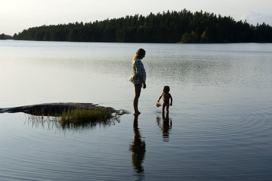 Mother and child by the water, Sweden.