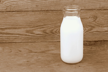 Milk and old style bottle on wood table