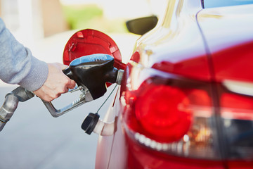 Pumping gas at gas pump